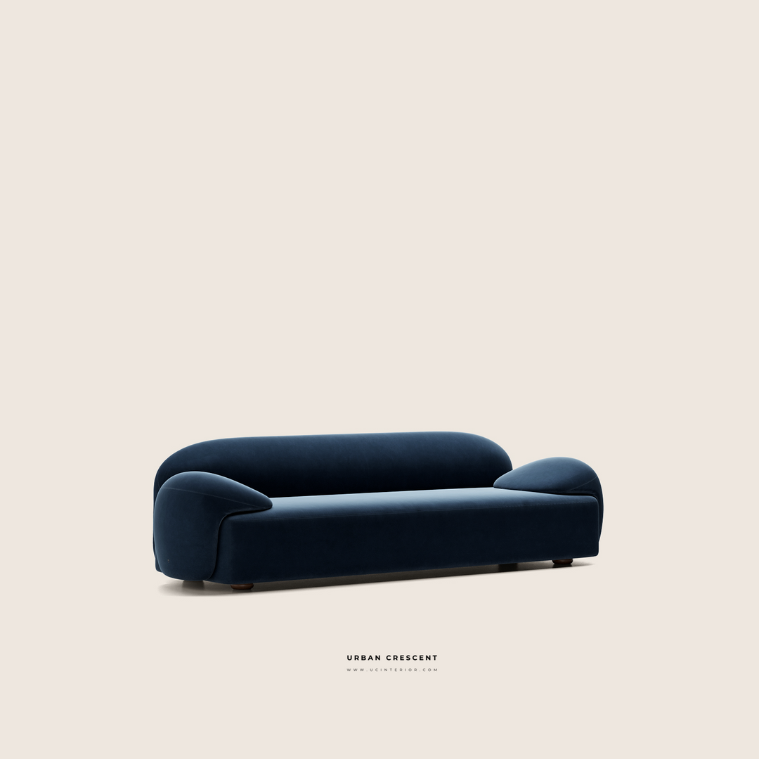 Navy blue sofa on a beige background with 'Urban Croissant' branding.